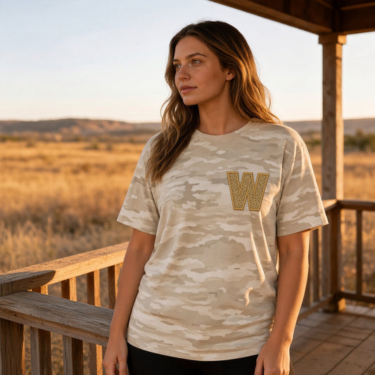 Natural camo tee with gold embroidered appliqué W on the left chest, worn on model