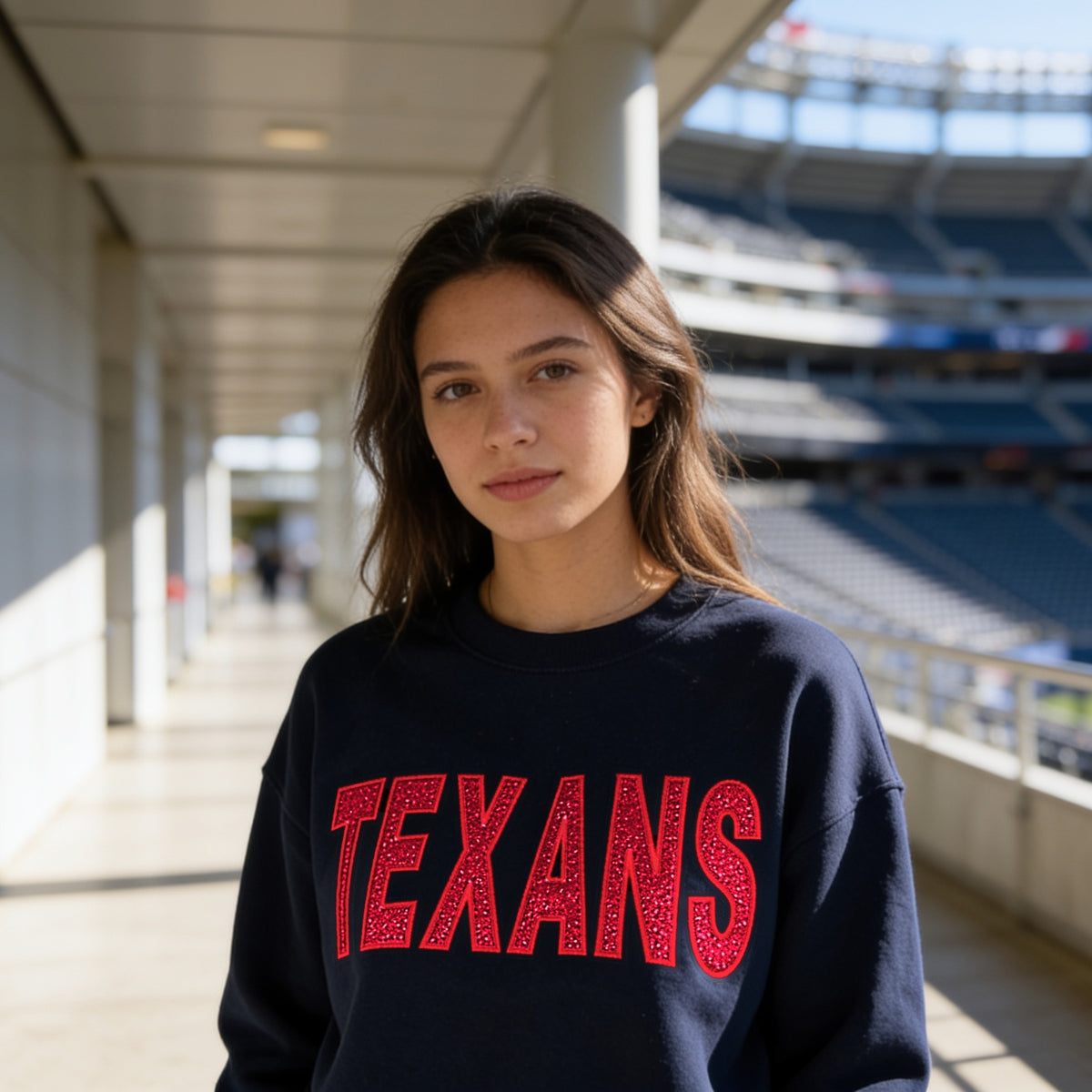 Navy crewneck sweatshirt with TEXANS in red glitter embroidered appliqué